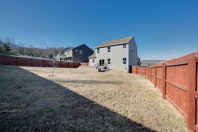 rear view of property with a lawn