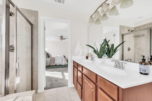 bathroom featuring tile patterned flooring, vanity, a shower with shower door, and ceiling fan