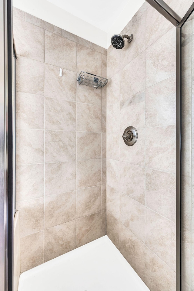 bathroom with a tile shower