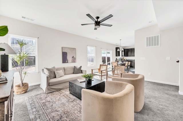 living room with ceiling fan and carpet flooring