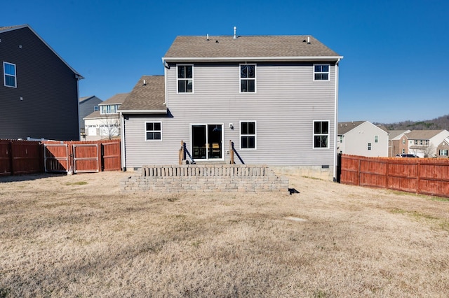 back of house featuring a patio and a lawn