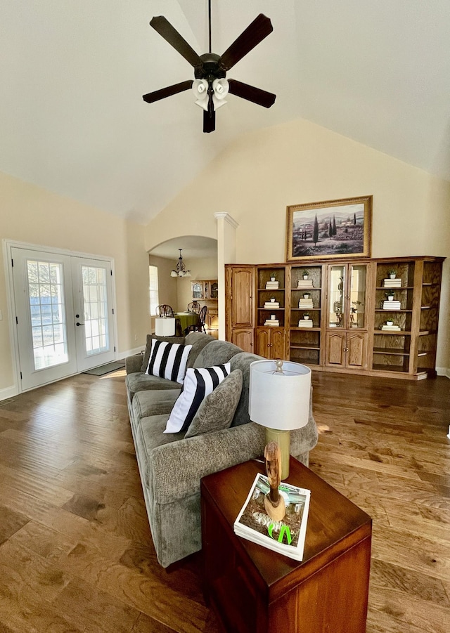 living room with high vaulted ceiling, hardwood / wood-style floors, ceiling fan, and french doors