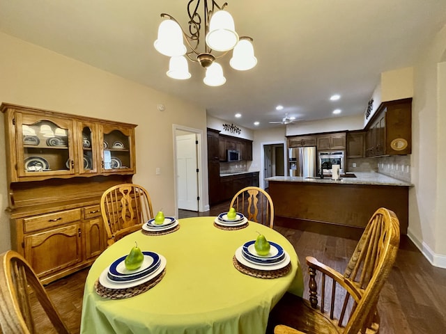 dining area with an inviting chandelier and dark wood-type flooring