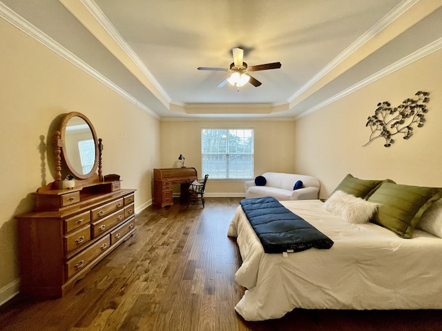 bedroom with ceiling fan, ornamental molding, dark hardwood / wood-style floors, and a raised ceiling