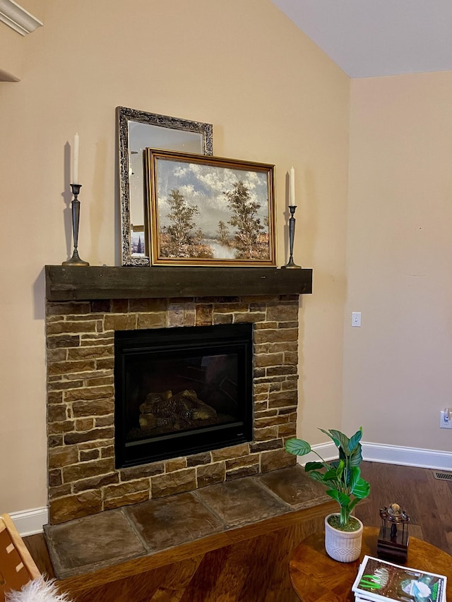 interior details featuring a fireplace, baseboards, and wood finished floors