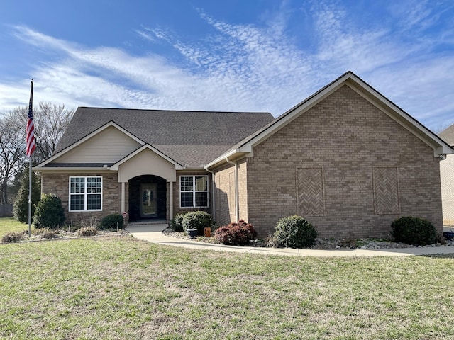 single story home with brick siding and a front lawn