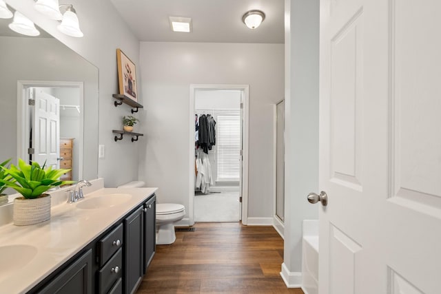 full bathroom featuring toilet, vanity, shower with separate bathtub, and hardwood / wood-style floors