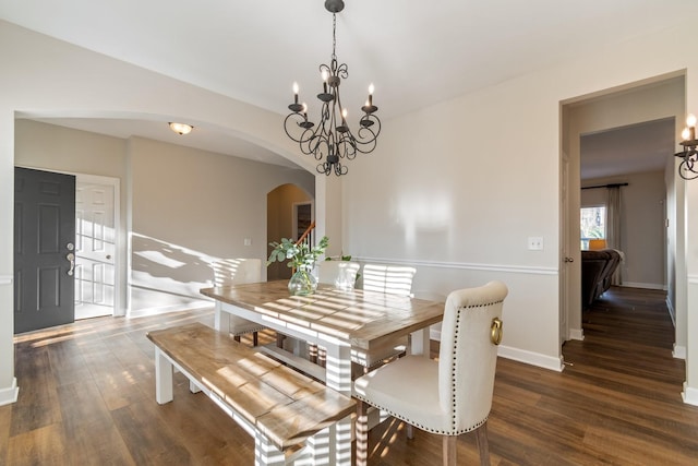 dining area featuring a notable chandelier and dark hardwood / wood-style floors