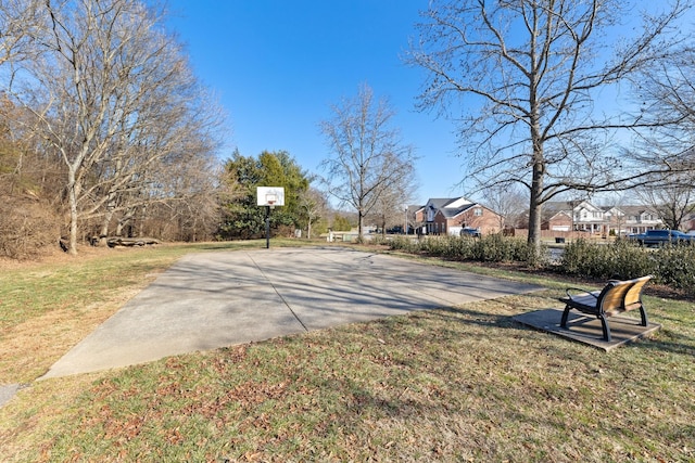 view of basketball court with a yard