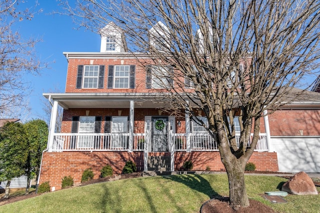 view of front of home with a porch and a front lawn