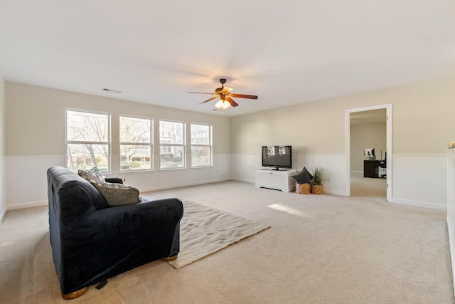 living room featuring light carpet and ceiling fan