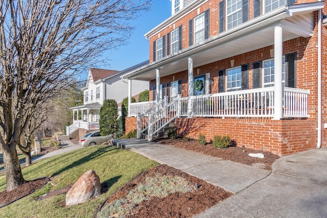 view of front facade with a porch and a front yard