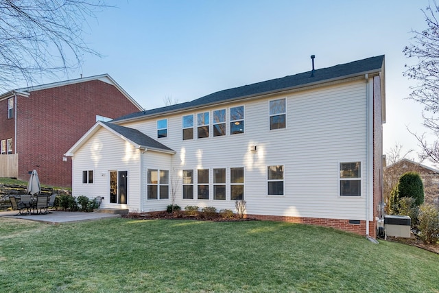 back of property featuring a patio area and a lawn