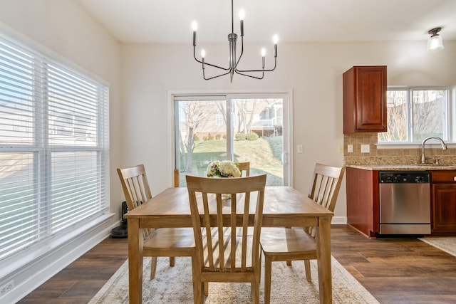 dining area featuring an inviting chandelier, dark hardwood / wood-style floors, and sink