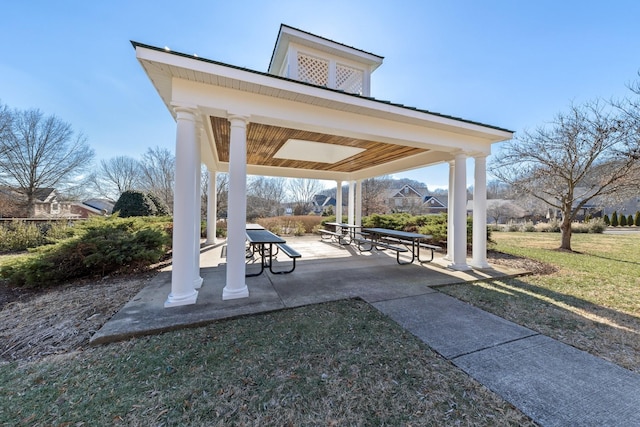 view of community featuring a yard, a gazebo, and a patio