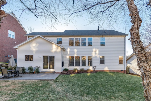 rear view of house with a patio and a yard