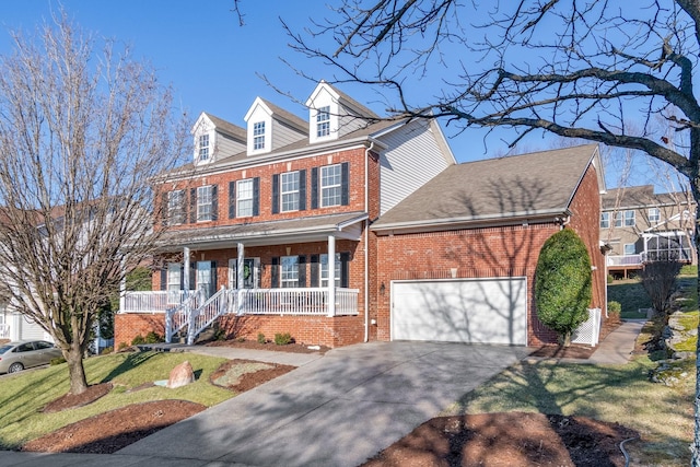 view of front of house with a garage, a front yard, and covered porch