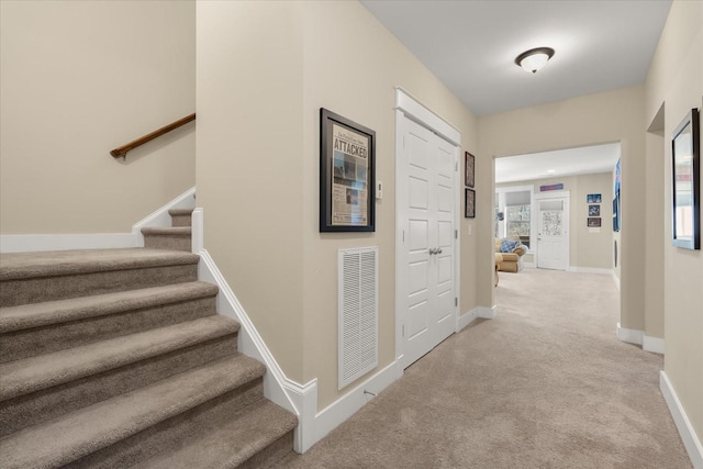 hall featuring light colored carpet