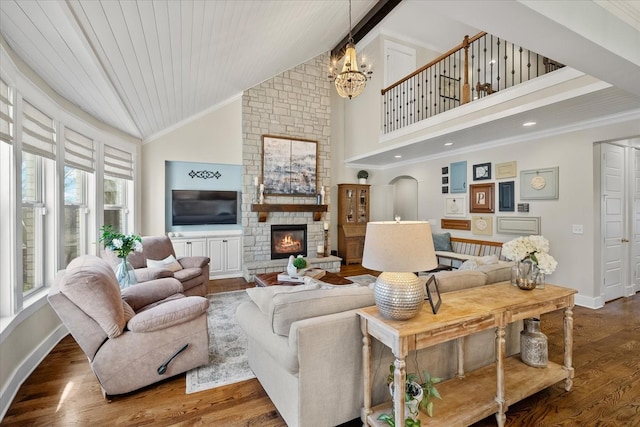 living room with a fireplace, wood-type flooring, a chandelier, crown molding, and wooden ceiling