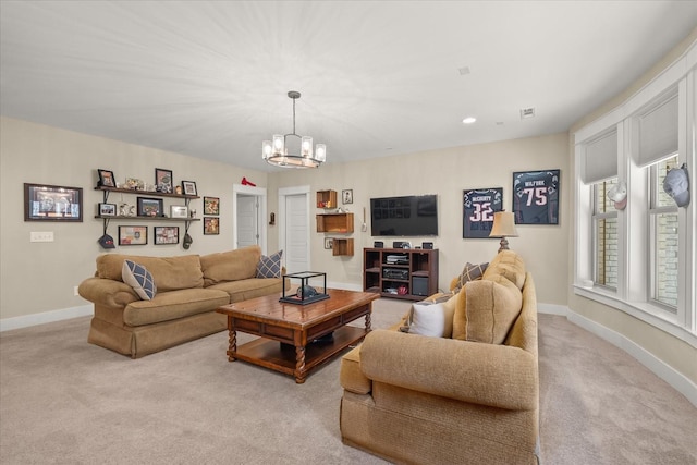 living room featuring an inviting chandelier and light colored carpet