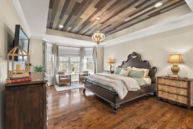 bedroom with crown molding, a tray ceiling, dark hardwood / wood-style flooring, and an inviting chandelier