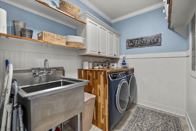 washroom with sink, crown molding, tile patterned flooring, cabinets, and separate washer and dryer