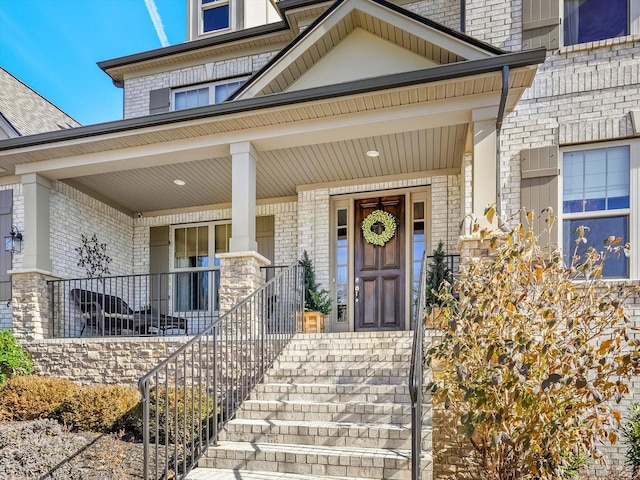 view of exterior entry featuring a porch