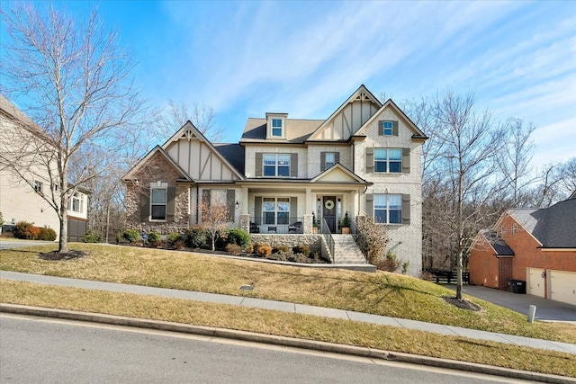 view of front of house with covered porch and a front lawn