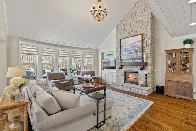 living room with wood-type flooring, ornamental molding, wood ceiling, and a fireplace