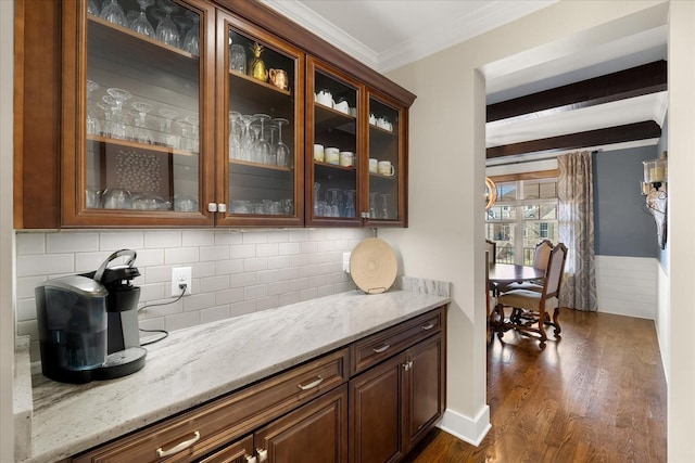 bar with dark hardwood / wood-style flooring, decorative backsplash, light stone counters, crown molding, and beam ceiling