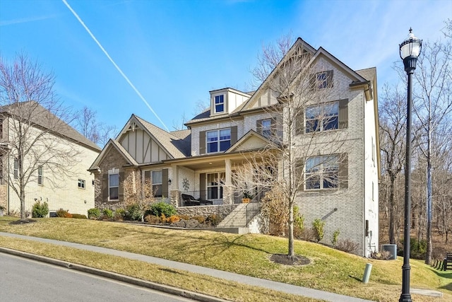 view of front of house featuring central AC, covered porch, and a front lawn