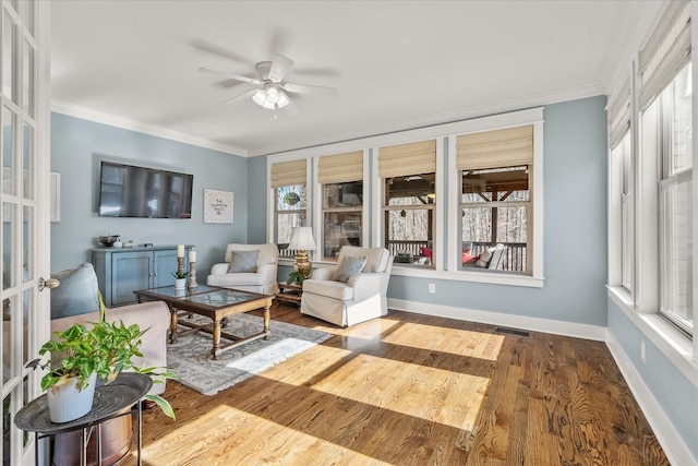 sunroom / solarium featuring ceiling fan