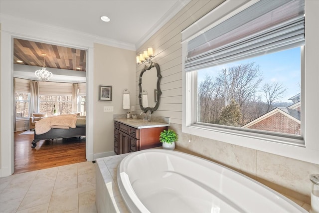 bathroom featuring wood walls, ornamental molding, vanity, a relaxing tiled tub, and tile patterned floors