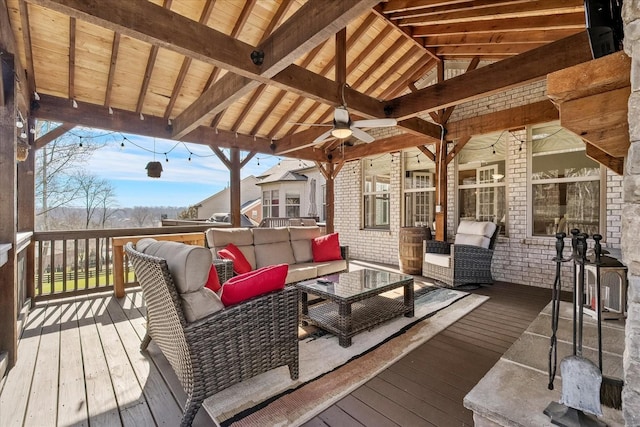 deck with ceiling fan and an outdoor living space