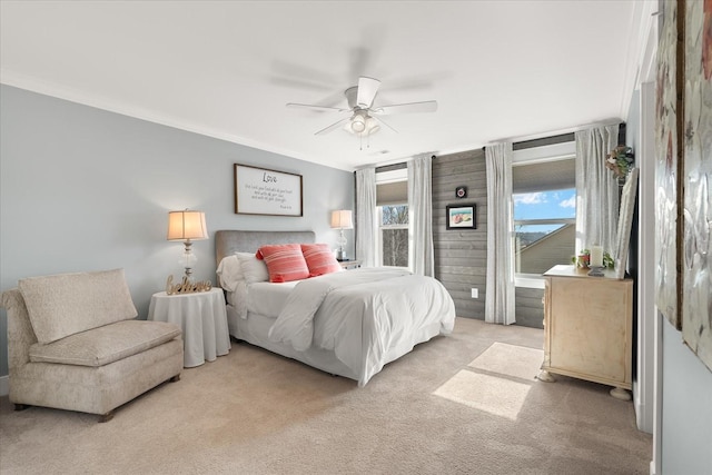 bedroom featuring ornamental molding, light colored carpet, and ceiling fan