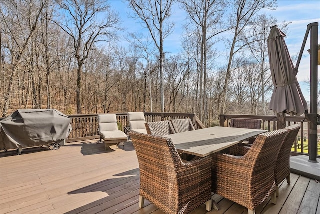 wooden deck featuring a grill