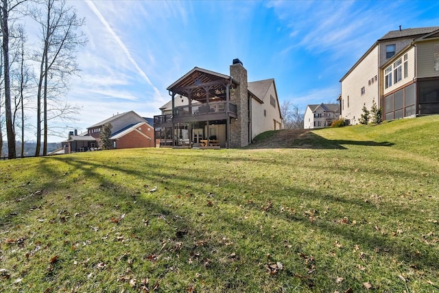 rear view of property featuring a yard