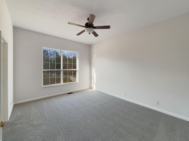 spare room featuring carpet flooring, a textured ceiling, and ceiling fan