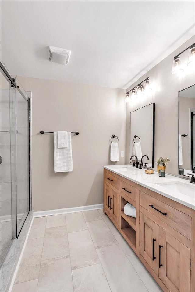 bathroom with vanity and a shower with shower door