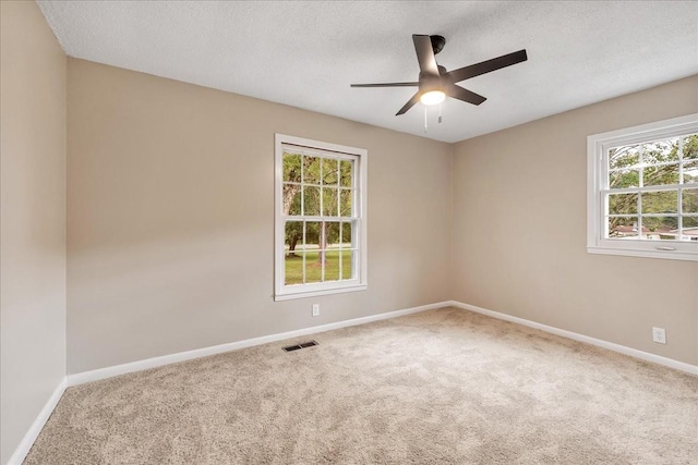 spare room with ceiling fan, carpet floors, and a textured ceiling