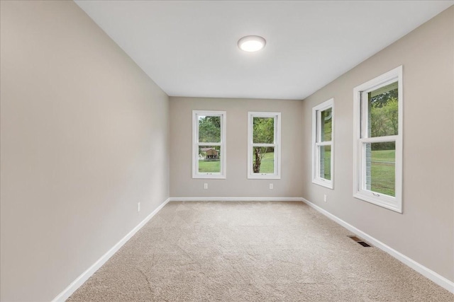 unfurnished room with light colored carpet