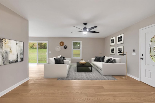 living room featuring light hardwood / wood-style flooring and ceiling fan