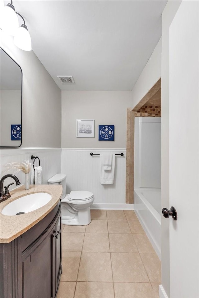 bathroom with vanity, tile patterned floors, and toilet