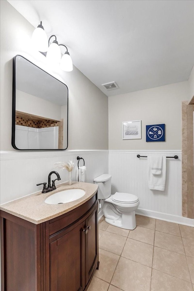 bathroom featuring tile patterned floors, vanity, and toilet