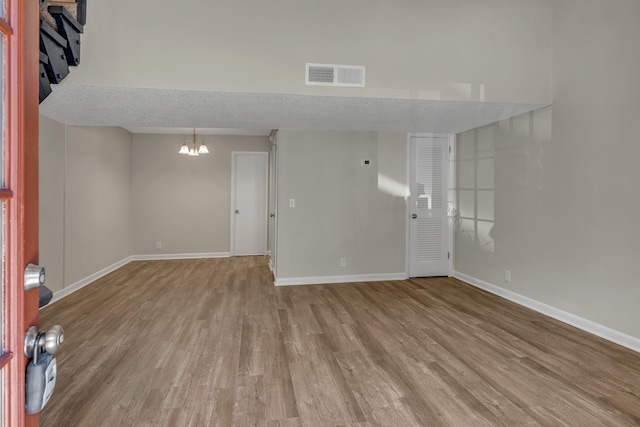 interior space with an inviting chandelier and light hardwood / wood-style flooring