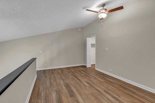 unfurnished room with ceiling fan, hardwood / wood-style floors, and a textured ceiling