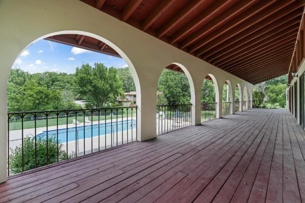 deck featuring a fenced in pool