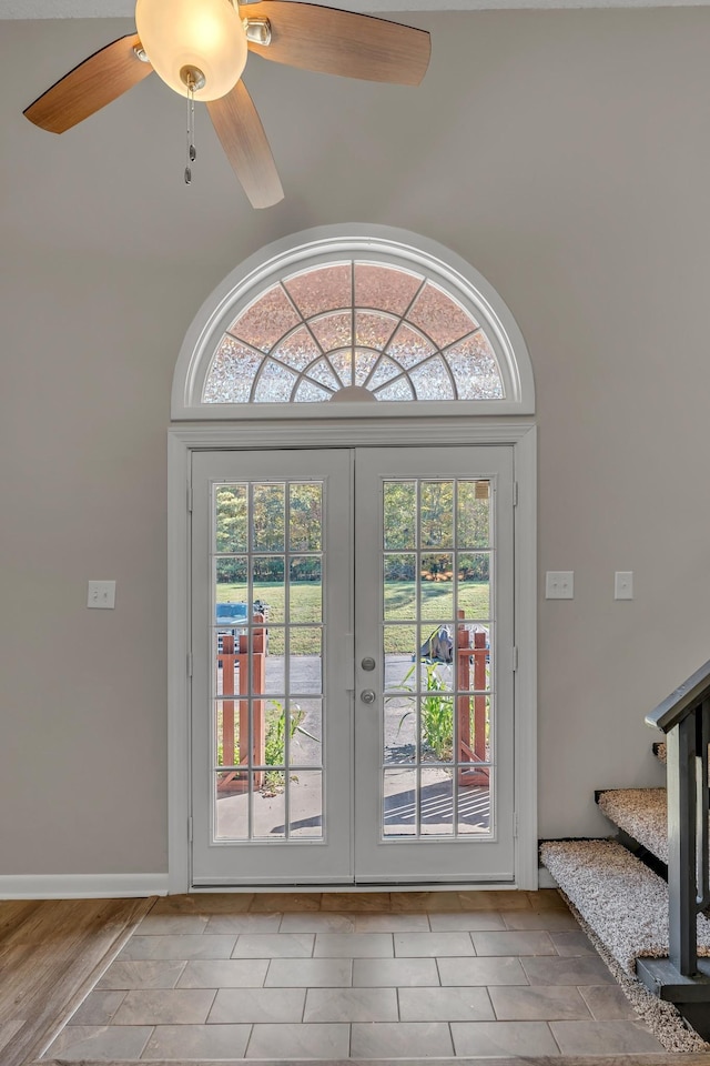 doorway with a towering ceiling and ceiling fan