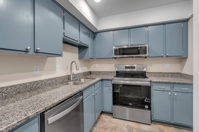 kitchen with blue cabinetry, appliances with stainless steel finishes, and sink