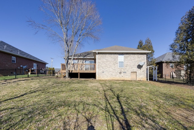 rear view of property featuring a yard and a deck